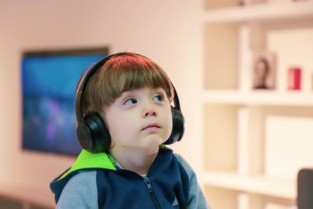 A young kid with headphones on